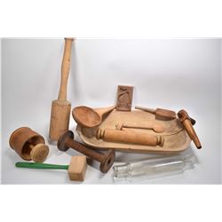 Selection of primitive kitchen treenware including dough bowl, butter molds, mallet, rolling pins et
