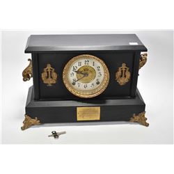 Antique simulated slate chiming mantle clock with attached ormolu style decoration manufactured by t