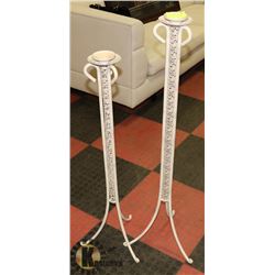 PAIR OF METAL FLOOR CANDLE HOLDERS.