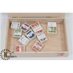 CIGAR BOX WITH 10 X 100 CANADIAN STAMPS.