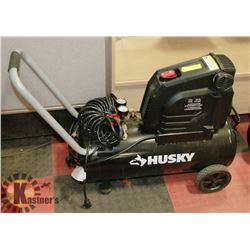 NEW HUSKY 8 GALLON AIR COMPRESSOR.