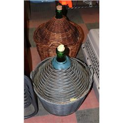 2 LARGE WINE JUGS IN BASKETS