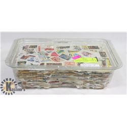1-3/4 POUNDS OF WORLD STAMPS, MOST ARE CANADIAN