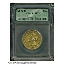 1877-S $10 AU50 ICG. Myriad small contact marks a