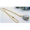 Image 1 : Porcelain egg with gold accents on an 18 chain