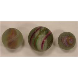 Three candy stripe swirl marbles
