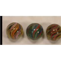 Three candy stripe swirl marbles