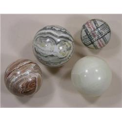 Four extra large marbles