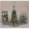 Image 1 : Four containers of machine marbles
