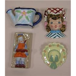 Four unmarked figural wall pockets, girl