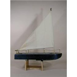 Wood sail boat w/eagle on top of mast