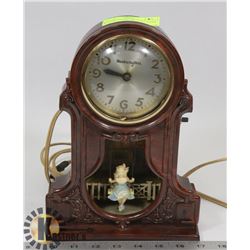 VINTAGE BAKEALITE SWIRL CLOCK W/ LIGHT UP GIRL ON