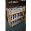Image 1 : Blond three tier book shelf filled with contemporary novels ie: Oprah's book club etc.