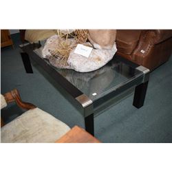 Quality designer coffee table with curved glass top and stainless steel accents