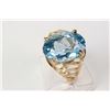 Image 1 : Ladies 10kt yellow gold ring set with large faceted oval cut blue topaz gemstone