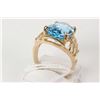 Image 2 : Ladies 10kt yellow gold ring set with large faceted oval cut blue topaz gemstone