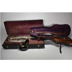 Vintage Saxophone in hard case and a Stravarius copy violin with two bows in a hard case