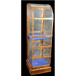 Small, floor model showcase w/ curved glass top