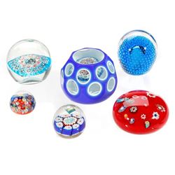 Six Art Glass paperweights.