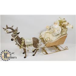 SANTA IN HIS SLED WITH A REINDEER.