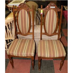 PAIR OF ANTIQUE DINING CHAIRS WITH CARVING ON TOP.