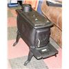Image 1 : CAST IRON LOG WOOD STOVE, 6" PIPE REQUIRED,