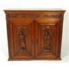 Image 1 : Walnut cupboard heavily carved with swag frieze and two medieval figures to the doors enclosing shel