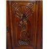 Image 4 : Walnut cupboard heavily carved with swag frieze and two medieval figures to the doors enclosing shel