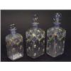Image 1 : Three fluted glass scent bottles and stoppers, all enamelled with swags of flowers and bows, largest