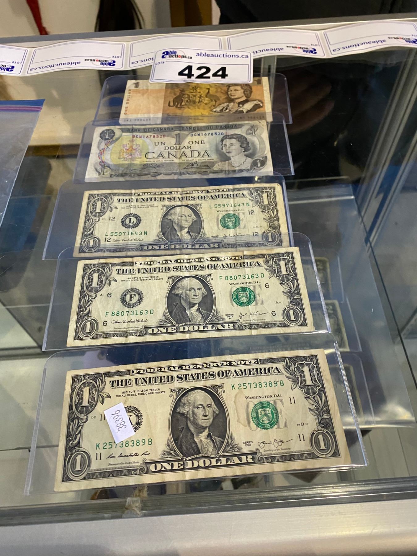 3 AMERICAN $1 BILLS, 1 CANADIAN $1 BILL AND 1 AUSTRALIAN $1 BILL