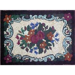 Hooked rug with center floral design, black borde