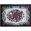 Hooked rug with center floral design, black borde