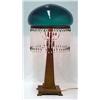 Metal lamp with green glass shade; gilt painted s