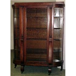Oak bent glass china cabinet with side columns; b