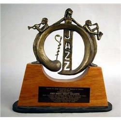 A BRONZE SCULPTURE RESTING ON WOODEN BASE Signed 