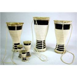 THREE WOOD, CORD, AND SKIN DRUMS Cuba '85, one inscribed Itotle, the next Iya, and the last Okonkolo