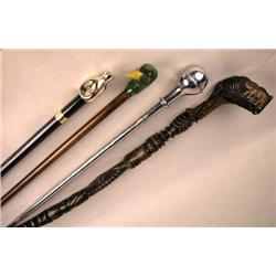 A MISCELLANEOUS GROUP OF FOUR WALKING STICKS Comprising a duck head example, a carved African piece,