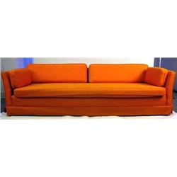 A CUSTOM MADE TANGERINE COLOR UPHOLSTERED SOFA Worn condition, 8'4"l