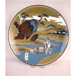 AN ORIENTAL STYLE CHARGER Depicting a river landscape of men carrying their Emperor across a river, 
