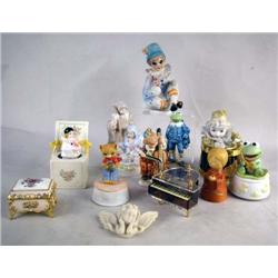 A GROUP OF ASSORTED PORCELAIN FIGURALS Including Kermit the Frog, Jesus, and musical boxes