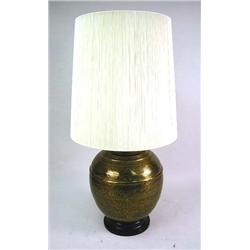 A LARGE BRASS LAMP WTH STRING SHADE Together with a round Oriental design black top brass table on t