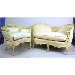 A LOUIS XV STYLE CARVED WHITE LACQUERED BARREL BACK ARMCHAIR Together with a matching love seat, eac