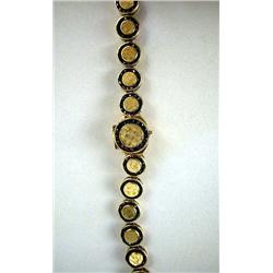 A LUCIEN PICARD 14K YELLOW GOLD WATCH With multiple circles with outer garnet and inner gold, apx. 1