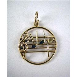 A 14K GOLD CHARM WITH MUSICAL NOTES AND STAFF Apx. 1.2 dwt.
