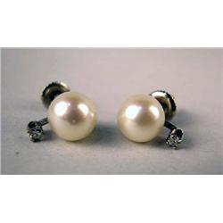 A PAIR OF 14K WHITE GOLD AND CULTURED PEARL EARRINGS Each set with a circular diamond, pearls apx. 7