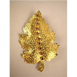 AN 18K YELLOW GOLD LEAF FORM BROOCH Stamped 18K, with ten natural rubies, total estimated weight apx