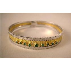 AN 18K YELLOW AND WHITE GOLD MESH STYLE BRACELET: With nine round emeralds, apx. total weight apx. 0