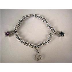 A 14K WHITE GOLD BRACELET WITH THREE CHARMS One o