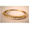 Image 1 : A 14K YELLOW GOLD BANGLE BRACELET With twenty-two round opal cabochons, apx. weight 9.50 dwt, missin