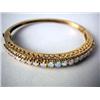 Image 4 : A 14K YELLOW GOLD BANGLE BRACELET With twenty-two round opal cabochons, apx. weight 9.50 dwt, missin